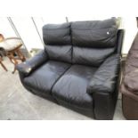 A BLACK LEATHER TWO SEATER SOFA