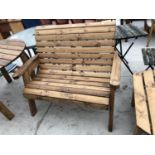 A TWO SEATER WOODEN GARDEN BENCH