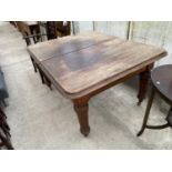 A MAHOGANY WIND OUT DINING TABLE