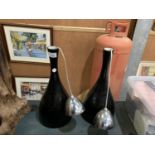 A PAIR OF BLACK VASE STYLE LAMPS