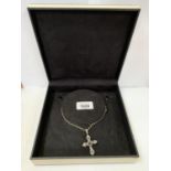 A WHITE METAL CROSS NECKLACE BOXED