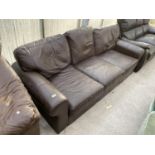 A BROWN LEATHER THREE SEATER SOFA