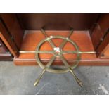 A VINTAGE BRASS SHIPS WHEEL