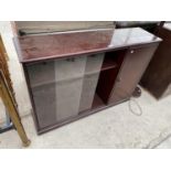 A MAHOGANY BOOKCASE WITH SINGLE DOOR AND TWO SLIDING GLASS DOORS