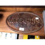 A CAST IRON 'ANTIQUES' OVAL SIGN