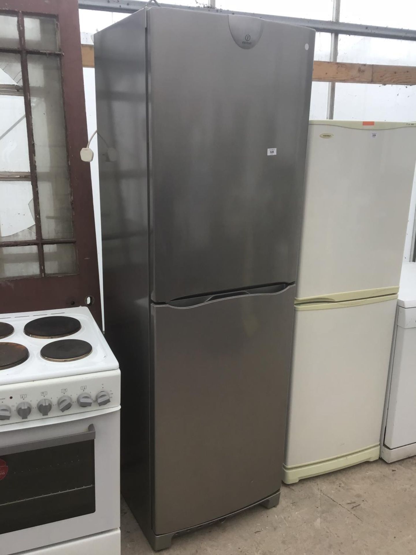 A SILVER INDESIT FRIDGE FREEZER IN WORKING ORDER