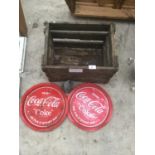 A VINTAGE CRATE (DAMAGE TO BOTTOM), TWO COCA COLA TRAYS AND A BELL