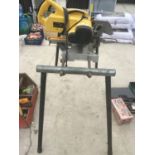 A DEWALT CHOP SAW ON A STAND IN WORKING ORDER