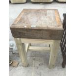 A BUTCHERS BLOCK ON A STAND