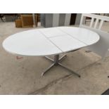 AN EXTENDING WHITE DINING TABLE ON BRUSHED CHROME PEDESTAL SUPPORT