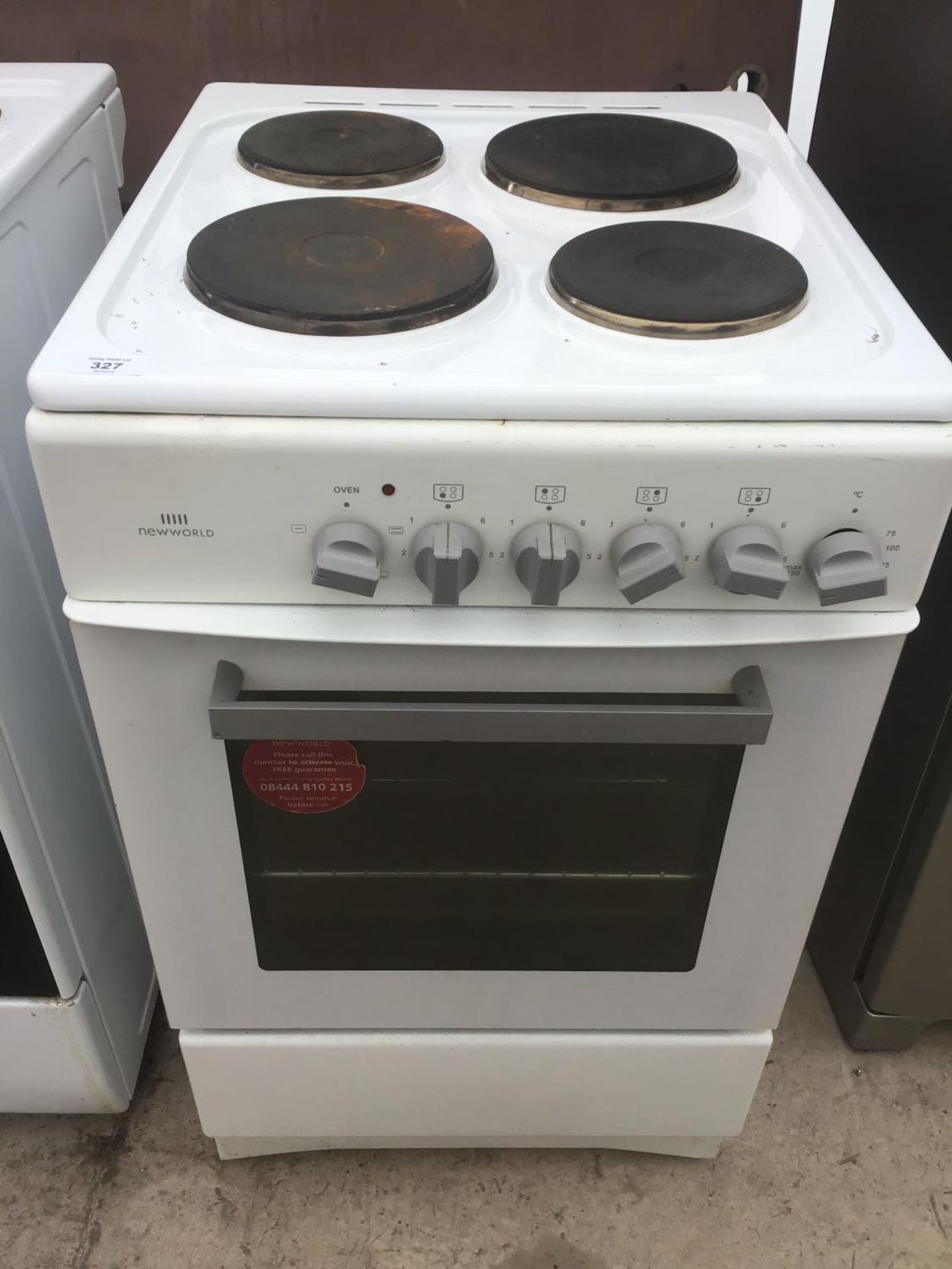 A NEW WORLD ELECTRIC OVEN WITH SOLID PLATE FOUR RING HOB (DIRECT WIRED)
