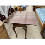 A VICTORIAN MAHOGANY FOLDING SIDE TABLE ON CABRIOLE SUPPORTS
