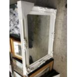 A LARGE WHITE ORNATE MIRROR