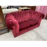 A RED CHESTERFIELD TWO SEATER SOFA