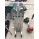 A SET OF ALUMINIUM TWELVE RUNG FOLDING LADDERS