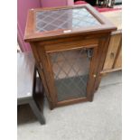 A PINE CABINET WITH A LEADED GLASS DOOR AND TOP