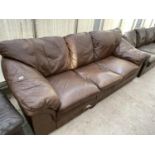 A BROWN LEATHER THREE SEATER SOFA