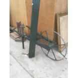 A GREEN PAINTED VINTAGE SEED DRILL IN GOOD CONDITION