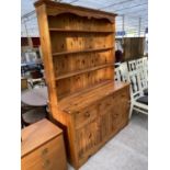 A MODERN PINE DRESSER WITH THREE DOORS, THREE DRAWERS AND THREE TIER PLATE RACK