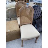 A PAIR OF LIGHT CHERRY RATTAN BACKED DINING CHAIRS WITH UPHOLSTERED SEATS