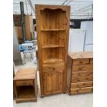 A PINE CORNER CABINET WITH LOWER DOOS