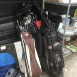 FOUR SETS OF GOLF CLUBS AND BAGS