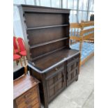 A PRIORY STYLE OAK DRESSER WITH TWO DOORS, TWO DRAWERS AND UPPER PLATE RACVK