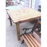 A SQUARE TOPPED WOODEN GARDEN TABLE