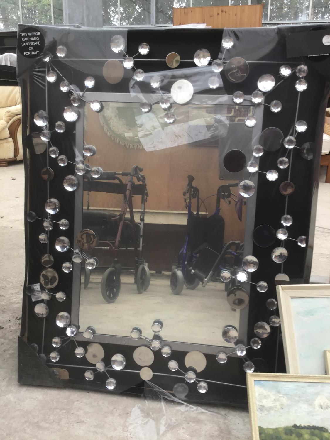 AN ORNATE MIRROR WITH CRYSTAL DECORATION