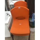 SIX RETRO ORANGE PLASTIC STACKING CHAIRS ON METAL SUPPORTS