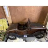 A VINTAGE WOODEN AND METAL CAR MODEL