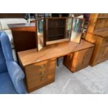 A STAG TEAK DRESSING TABLE WITH SIX DRAWERS AND A TRIPLE MIRROR