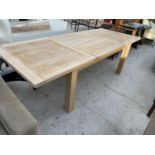 A MODERN EXTENDING OAK DINING TABLE