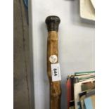 A 'STATES OF JERSEY' ENAMEL AND UNMARKED WHITE METAL TOPPED WALKING STICK
