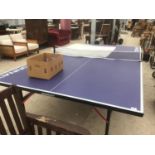 A FOLD UP DONNAY TABLE TENNIS TABLE IN VERY GOOD CONDITION WITH BATS AND BALLS
