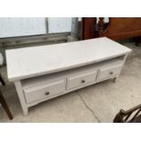 A WHITE COFFEE TABLE/SIDE CABINET WITH THREE DRAWERS