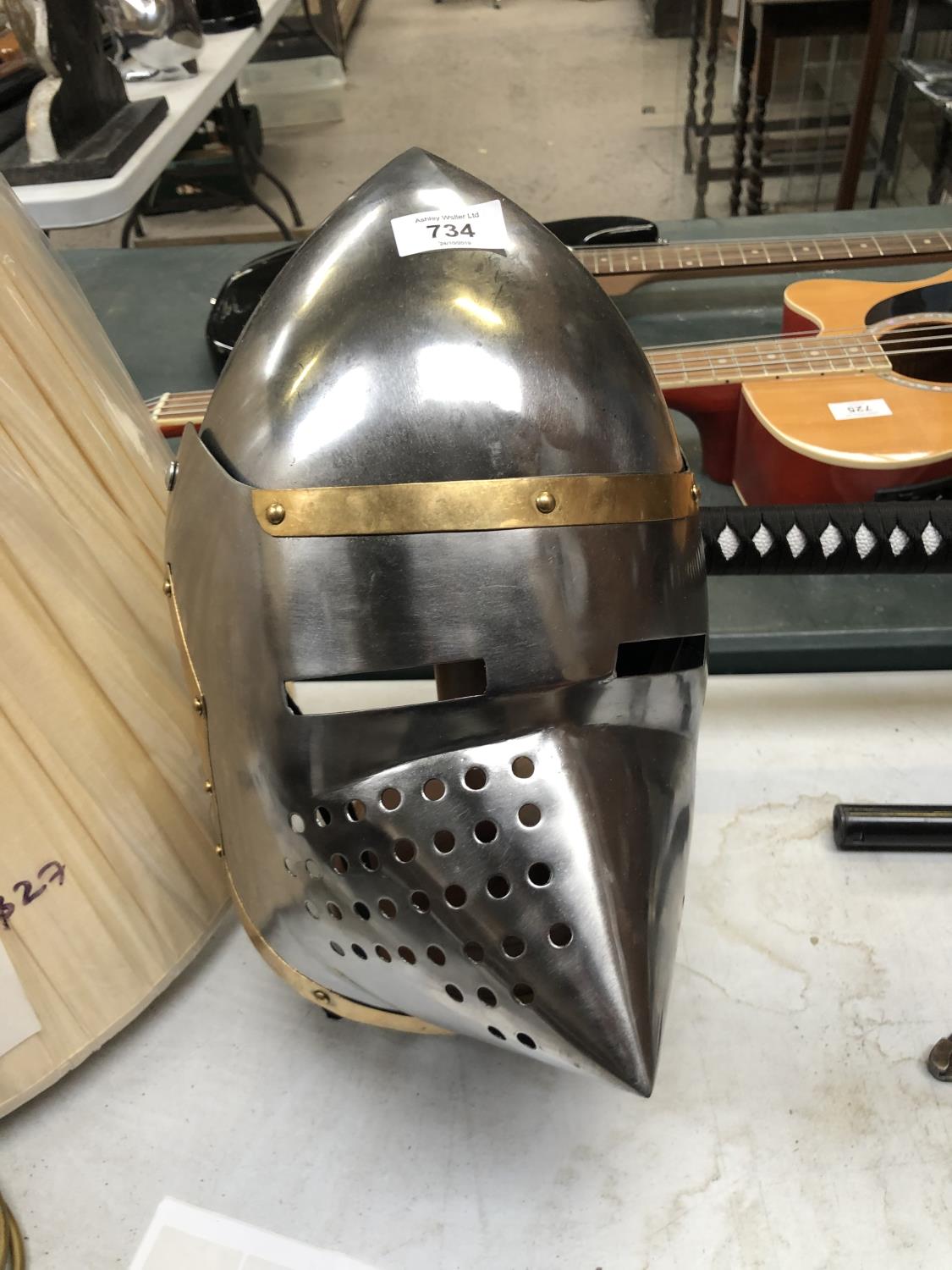 A DECORATIVE KNIGHTS METAL HELMET ON STAND