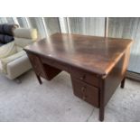 A MAHOGANY DESK WITH TWO SETS OF THREE SIDE DRAWERS AND CENTRE DRAWER