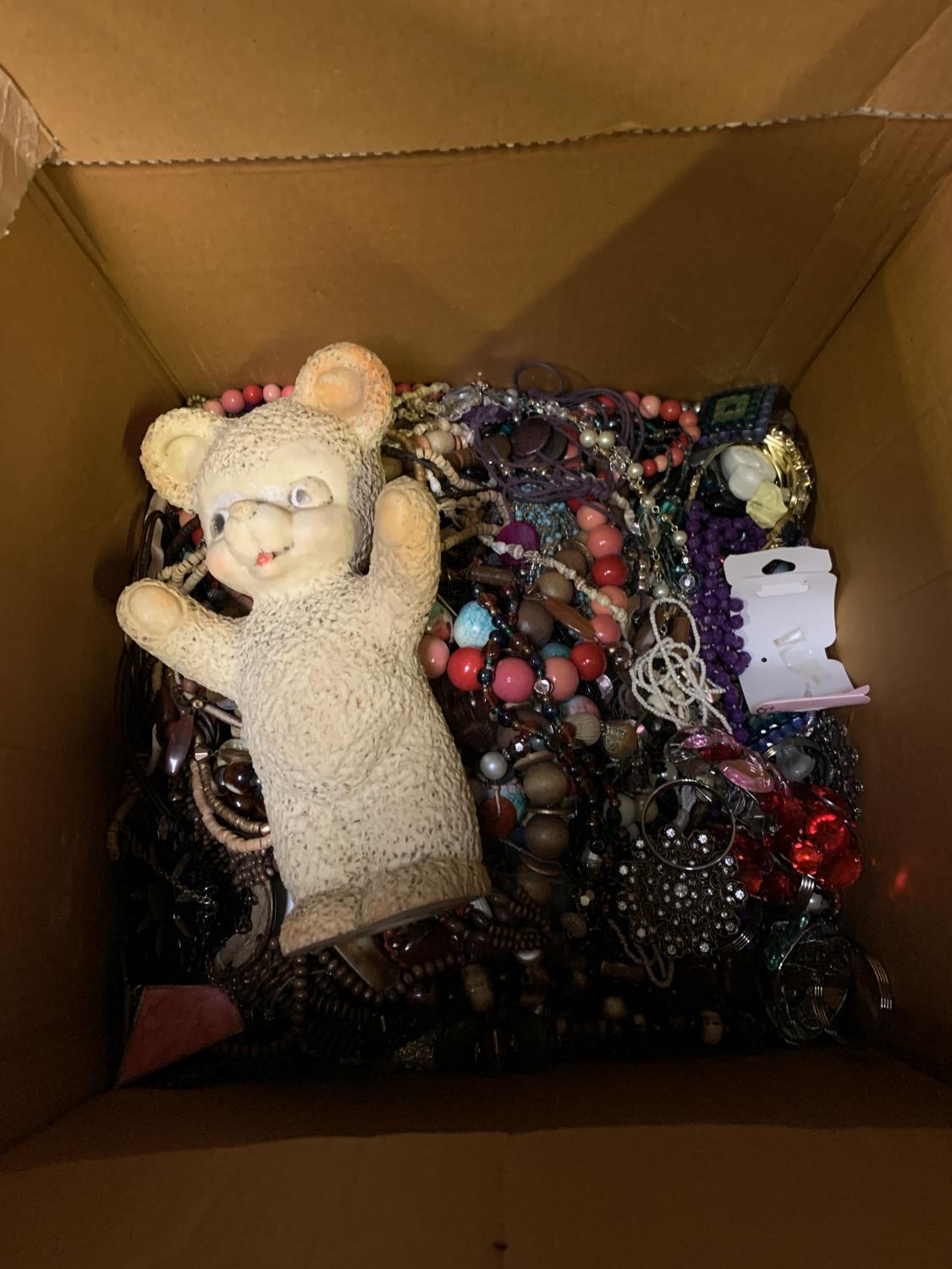 A LARGE CARDBOARD BOX OF COSTUME JEWELLERY TOGETHER WITH VINTAGE TOY