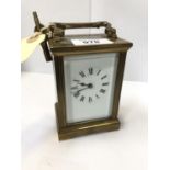 A BRASS CASED CARRIAGE CLOCK WITH KEY