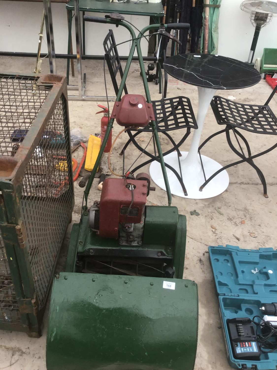 A PETROL DRIVEN CYLINDER MOWER WITH GRASS BOX IN WORKING ORDER