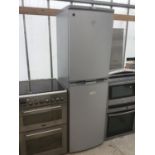 A SILVER ZANUSSI FRIDGE FREEZER IN WORKING ORDER (NO SHELVES AND IN NEED OF CLEAN)