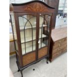 AN INLAID MAHOGANY CABINET ON CABRIOLE SUPPORTS WITH TWO GLAZED PANEL DOORS