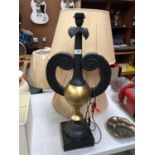 A BLACK AND GOLD LAMP BASE TOGETHER WITH TWO SHADES
