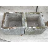 A PAIR OF SQUARE CONCRETE PLANTERS