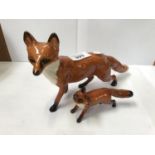TWO BESWICK CERAMIC FOX MODELS - SMALL ONE WITH TAIL RE-GLUED