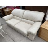 A CREAM LEATHER TWO SEATER SOFA