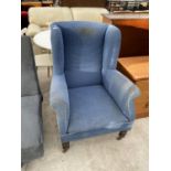 A BLUE WING BACK ARMCHAIR