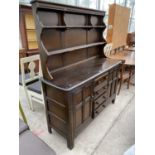 AN ERCOL ELM DRESSER WITH TWO DOORS FOUR DRAWERS AND UPPER SPLASHBACK