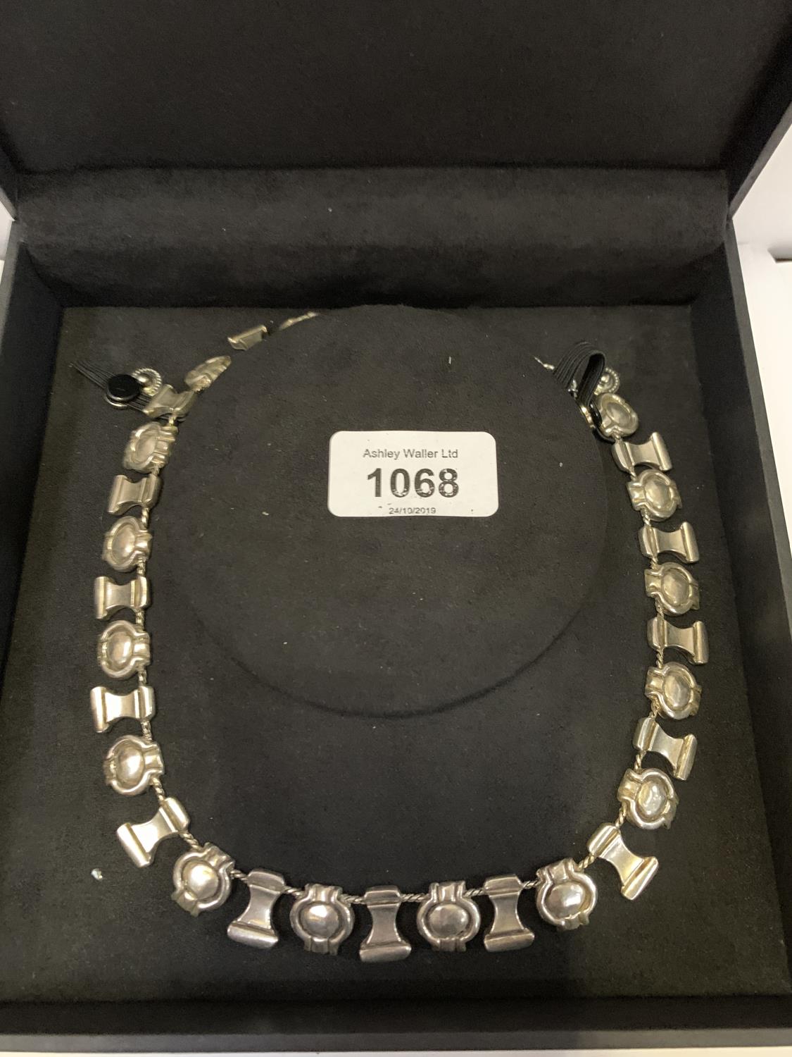 A BOXED WHITE METAL NECKLACE
